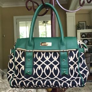 Colorful bag with leather trim and hidden pockets.